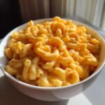 A bowl overflowing with creamy cottage cheese mac and cheese, showcasing the cheesy pasta.