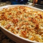 Close-up of a golden-brown baked Irresistible Chicken Cordon Bleu Casserole topped with breadcrumbs and parsley.