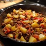 Close-up of an Irresistible Ground Beef and Potatoes Comfort Recipe cooked in a cast iron skillet.