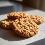 Close-up of Irresistible Peanut Butter Oatmeal Cookies with visible oats and a golden-brown texture.