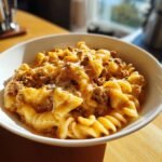 A bowl of One Pot Beef Cheddar Ranch Pasta with melted cheese and ground beef.