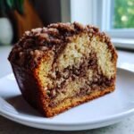 Close-up of a slice of Cinnamon Mocha Coffee Cake showing marbled cake and thick cinnamon streusel topping.