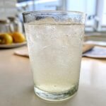 Close-up of a tall glass filled with bubbly, ice-cold Refreshing Homemade Lemonade.