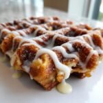 Close-up of an Irresistible Apple Fritter Waffle Donut drizzled with white icing.
