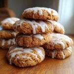 A close-up stack of Irresistible Pumpkin Pie Cookies topped with a white vanilla glaze drizzle.