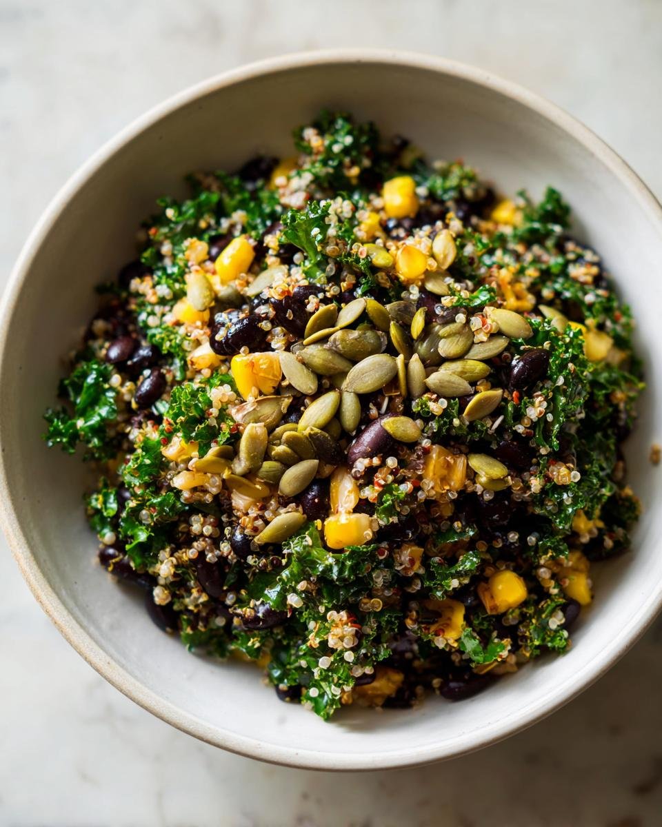Close-up of the Ultimate Summer BBQ Chopped Kale Salad featuring kale, quinoa, black beans, corn, and pumpkin seeds.