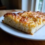 Close-up of a slice showing the airy, fluffy interior texture of the Gluten Free Pizza Crust with a golden, cheesy top.