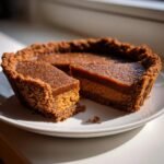 A slice cut from an Irresistible Apple Butter Pie featuring a thick Biscoff cookie crust and dual layers of filling.