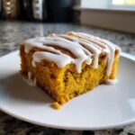 A close-up of a square slice of Irresistible Healthy Pumpkin Bars topped with a white glaze.