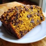 Close-up of three moist slices of Irresistible Pumpkin Chocolate Chip Bread loaded with dark chocolate chips.