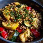 Close-up of a Jerk Vegetable Farro Bowl featuring farro, grilled zucchini, red peppers, and maple herb apples, topped with parsley.