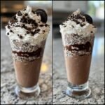 Two views of a tall glass filled with a thick, chocolate Oreo Milkshake, layered with cookie crumbs and topped with whipped cream and a whole Oreo.