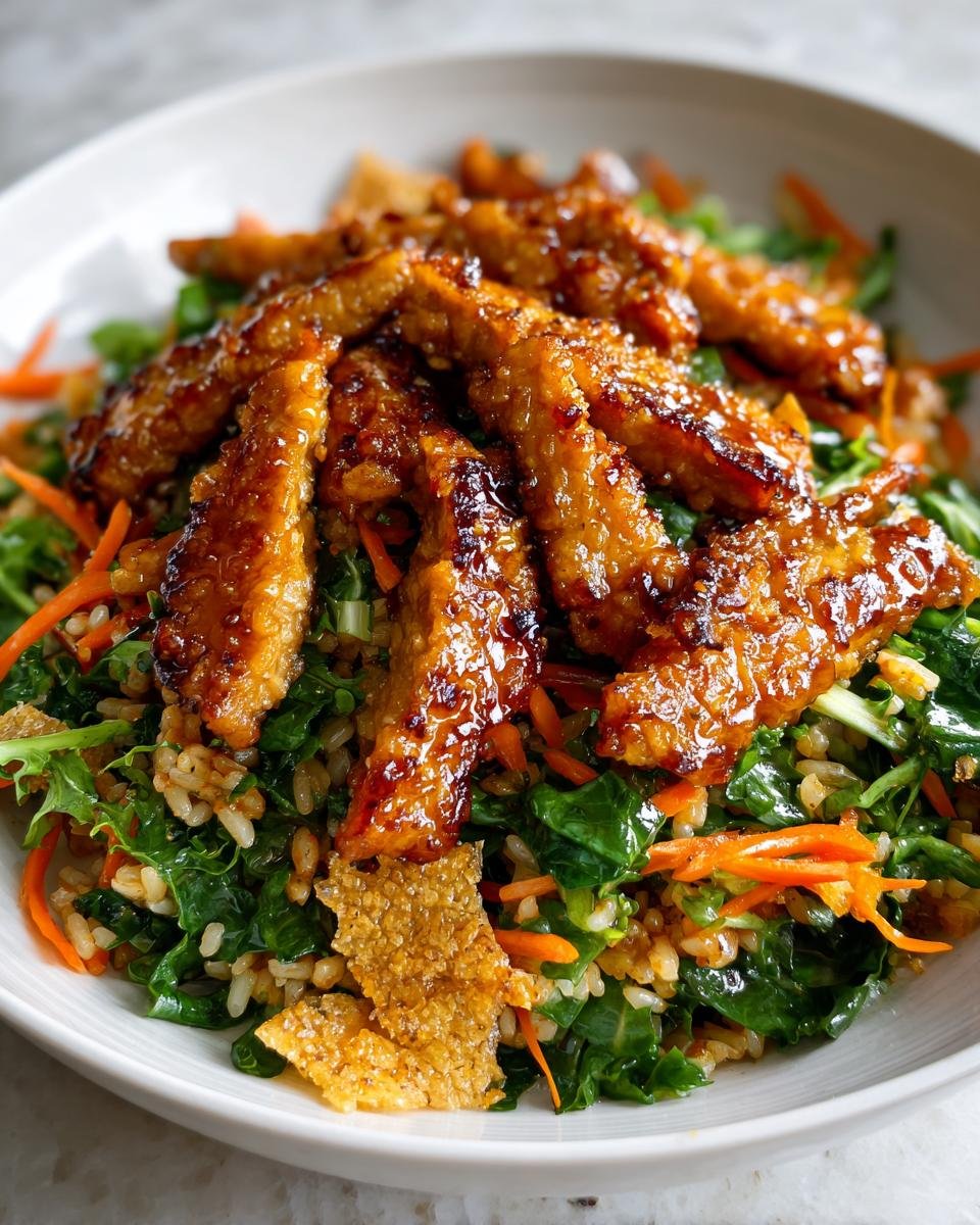 Close-up of Irresistible Teriyaki Chicken Crispy Rice Salad topped with glazed, crispy chicken strips.