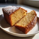 Close-up of a slice cut from an Irresistible Applesauce Cake, dusted with powdered sugar.