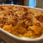 Close-up of an Irresistible Butternut Squash Casserole baked in a white dish with a golden brown, crunchy crumb topping.