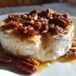 Close-up of an Irresistible Maple Pecan Baked Brie Appetizer, warm and gooey with caramelized pecans.
