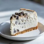 A perfect slice of Irresistible Mulberry Earl Grey Cheesecake Delight on a white plate.