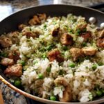 Close-up of Tropical Coconut Lime Chicken Rice Skillet with seared chicken pieces and bright green lime zest.